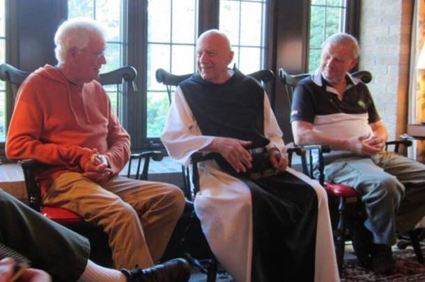 A group of old men sitting in chairs

Description automatically generated