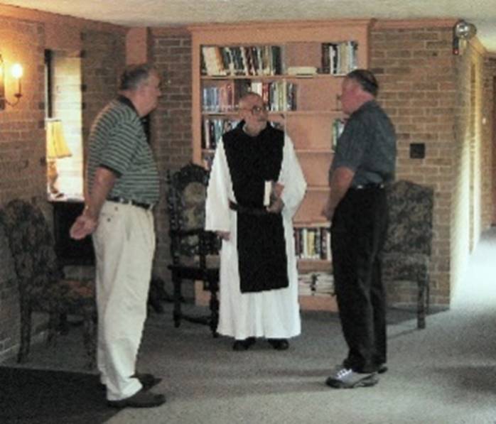 A group of men standing in a room

Description automatically generated with medium confidence